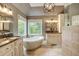 Bright bathroom with dual vanities, soaking tub, and walk-in shower at 3510 Woodbury Creek Dr, Cumming, GA 30041