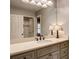 Well lit bathroom featuring a modern sink, a vanity and tiled walls at 3510 Woodbury Creek Dr, Cumming, GA 30041