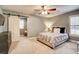 Carpeted bedroom featuring a barn door, dresser and a comfortable bed at 3510 Woodbury Creek Dr, Cumming, GA 30041
