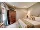 Comfortable bedroom with a queen sized bed, large armoire, and soft natural light at 3510 Woodbury Creek Dr, Cumming, GA 30041