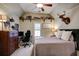 Cozy bedroom featuring a tray ceiling, carpeted floors and a warm decor at 3510 Woodbury Creek Dr, Cumming, GA 30041