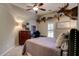 Comfortable bedroom featuring a tray ceiling, carpeted floors and a warm decor at 3510 Woodbury Creek Dr, Cumming, GA 30041