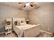 Cozy bedroom with a plush bed, soft carpeting, lamps, and a ceiling fan for added comfort at 3510 Woodbury Creek Dr, Cumming, GA 30041