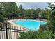 Community pool surrounded by lounge chairs and lush greenery, offering a relaxing and inviting atmosphere at 3510 Woodbury Creek Dr, Cumming, GA 30041