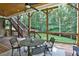 Beautiful covered back porch with wooden ceiling, stairs to backyard, and outdoor seating area at 3510 Woodbury Creek Dr, Cumming, GA 30041