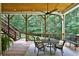 Beautiful covered back deck with wooden ceiling, stairs to backyard, and outdoor seating at 3510 Woodbury Creek Dr, Cumming, GA 30041