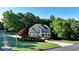 Charming two-story home features a well-manicured lawn and lush landscaping for great curb appeal at 3510 Woodbury Creek Dr, Cumming, GA 30041