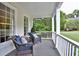 Inviting front porch with comfortable seating, perfect for relaxing and enjoying the outdoors at 3510 Woodbury Creek Dr, Cumming, GA 30041