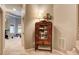 Hallway featuring carpet floors, an antique cabinet, and views into a exercise room at 3510 Woodbury Creek Dr, Cumming, GA 30041