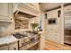 Well-appointed kitchen with stainless steel appliances and custom cabinetry and tile backsplash at 3510 Woodbury Creek Dr, Cumming, GA 30041