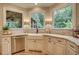 Gourmet kitchen boasts granite countertops, a stainless steel dishwasher, and backyard view at 3510 Woodbury Creek Dr, Cumming, GA 30041