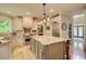 Bright kitchen with custom cabinets, a large center island, stainless appliances, and hardwood floors at 3510 Woodbury Creek Dr, Cumming, GA 30041