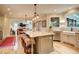 Eat-in kitchen featuring a long island with seating, farmhouse sink, and a view to the living room at 3510 Woodbury Creek Dr, Cumming, GA 30041