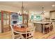 Open kitchen features a center island, stainless appliances, wooden floors and a connected porch with a stone fireplace at 3510 Woodbury Creek Dr, Cumming, GA 30041