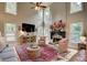 Spacious living room with high ceilings, lots of natural light, and a cozy fireplace at 3510 Woodbury Creek Dr, Cumming, GA 30041