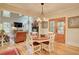 Open living room with hardwood floors, fireplace, and views to the trees outside at 3510 Woodbury Creek Dr, Cumming, GA 30041