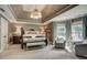 Relaxing bedroom with tray ceiling, sitting area, and soft, neutral colors at 3510 Woodbury Creek Dr, Cumming, GA 30041