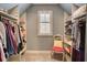 Organized walk-in closet with custom shelves, a window, and carpeted floors at 3510 Woodbury Creek Dr, Cumming, GA 30041