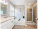 Bathroom featuring a bathtub, shower with a glass door and double sinks at 3799 Chattahoochee Summit Se Dr # 5, Atlanta, GA 30339