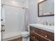 This bathroom has a tile shower, wood-look flooring, and a wood cabinet sink with a mirror at 3799 Chattahoochee Summit Se Dr # 5, Atlanta, GA 30339