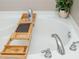 Close-up of a bathtub featuring a wooden tray and chrome fixtures at 3799 Chattahoochee Summit Se Dr # 5, Atlanta, GA 30339