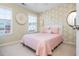 Comfortable bedroom with a geometrically patterned wall, white headboard, and two windows at 3799 Chattahoochee Summit Se Dr # 5, Atlanta, GA 30339