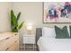 Bright bedroom features an art piece, a modern nightstand and plant at 3799 Chattahoochee Summit Se Dr # 5, Atlanta, GA 30339