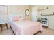 Bright bedroom featuring geometric wallpaper, decor mirror, comfortable bed, and bookshelves at 3799 Chattahoochee Summit Se Dr # 5, Atlanta, GA 30339