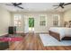 A spacious bedroom with wood floors has lots of natural light from the windows and access to the outdoors at 3799 Chattahoochee Summit Se Dr # 5, Atlanta, GA 30339