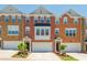 Charming red brick townhouse with a well-manicured front yard and attached garage, perfect for modern living at 3799 Chattahoochee Summit Se Dr # 5, Atlanta, GA 30339
