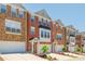 Attractive brick townhomes, showcasing a desirable neighborhood setting with neat landscaping and attached garages at 3799 Chattahoochee Summit Se Dr # 5, Atlanta, GA 30339