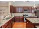 Kitchen with granite counters, stainless steel appliances, and cherry wood cabinets at 3799 Chattahoochee Summit Se Dr # 5, Atlanta, GA 30339