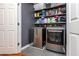 Modern laundry room featuring stainless steel washer and dryer with wood shelving at 3799 Chattahoochee Summit Se Dr # 5, Atlanta, GA 30339