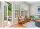 Bright living room with large windows, comfortable seating, and access to the deck at 3799 Chattahoochee Summit Se Dr # 5, Atlanta, GA 30339