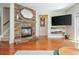 Modern living room featuring a stone fireplace, floating shelves, and a view to the stairs at 3799 Chattahoochee Summit Se Dr # 5, Atlanta, GA 30339