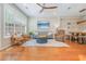 Bright living room featuring hardwood floors, a ceiling fan, comfortable seating, and a dining area at 3799 Chattahoochee Summit Se Dr # 5, Atlanta, GA 30339