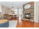 Open living room featuring a stone fireplace, hardwood floors, and a view to the dining area at 3799 Chattahoochee Summit Se Dr # 5, Atlanta, GA 30339