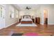 Spacious main bedroom with wood floors, ceiling fan, a comfortable bed, and an ensuite bathroom at 3799 Chattahoochee Summit Se Dr # 5, Atlanta, GA 30339