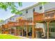 Rear exterior of multiple-story townhomes featuring individual wood decks and patios and green space at 3799 Chattahoochee Summit Se Dr # 5, Atlanta, GA 30339