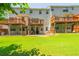 Rear exterior view of townhomes with decks overlooking green lawns with trees under a partly cloudy sky at 3799 Chattahoochee Summit Se Dr # 5, Atlanta, GA 30339