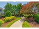 Curving walking path with landscaped plants and mulch under a canopy of trees on a partly cloudy day at 3799 Chattahoochee Summit Se Dr # 5, Atlanta, GA 30339