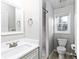 Bright bathroom featuring gray walls, modern fixtures, and tile surround shower at 551 Floyd Se Dr, Smyrna, GA 30082