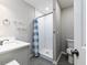 Bathroom with a glass enclosed tiled shower, modern fixtures, and tile flooring at 551 Floyd Se Dr, Smyrna, GA 30082