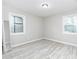 Bedroom features two large windows, hardwood floors, and neutral gray colored walls at 551 Floyd Se Dr, Smyrna, GA 30082