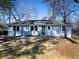 Charming single-story home featuring a gray exterior, white trim, and a well-manicured front yard at 551 Floyd Se Dr, Smyrna, GA 30082