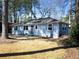 Cozy one-story house with a gray exterior, white framed windows, and a green front yard at 551 Floyd Se Dr, Smyrna, GA 30082