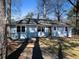 Exterior of home with a light gray front, brick underlay, and asphalt driveway at 551 Floyd Se Dr, Smyrna, GA 30082