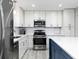 Modern kitchen featuring stainless steel appliances and white cabinets at 551 Floyd Se Dr, Smyrna, GA 30082