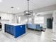 Open-concept living room and kitchen area with modern lighting and stylish furniture at 551 Floyd Se Dr, Smyrna, GA 30082