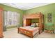 Cozy bedroom featuring a bunk bed with green painted walls, window with natural light, and wooden furniture at 1967 Mason Mill Rd, Decatur, GA 30033